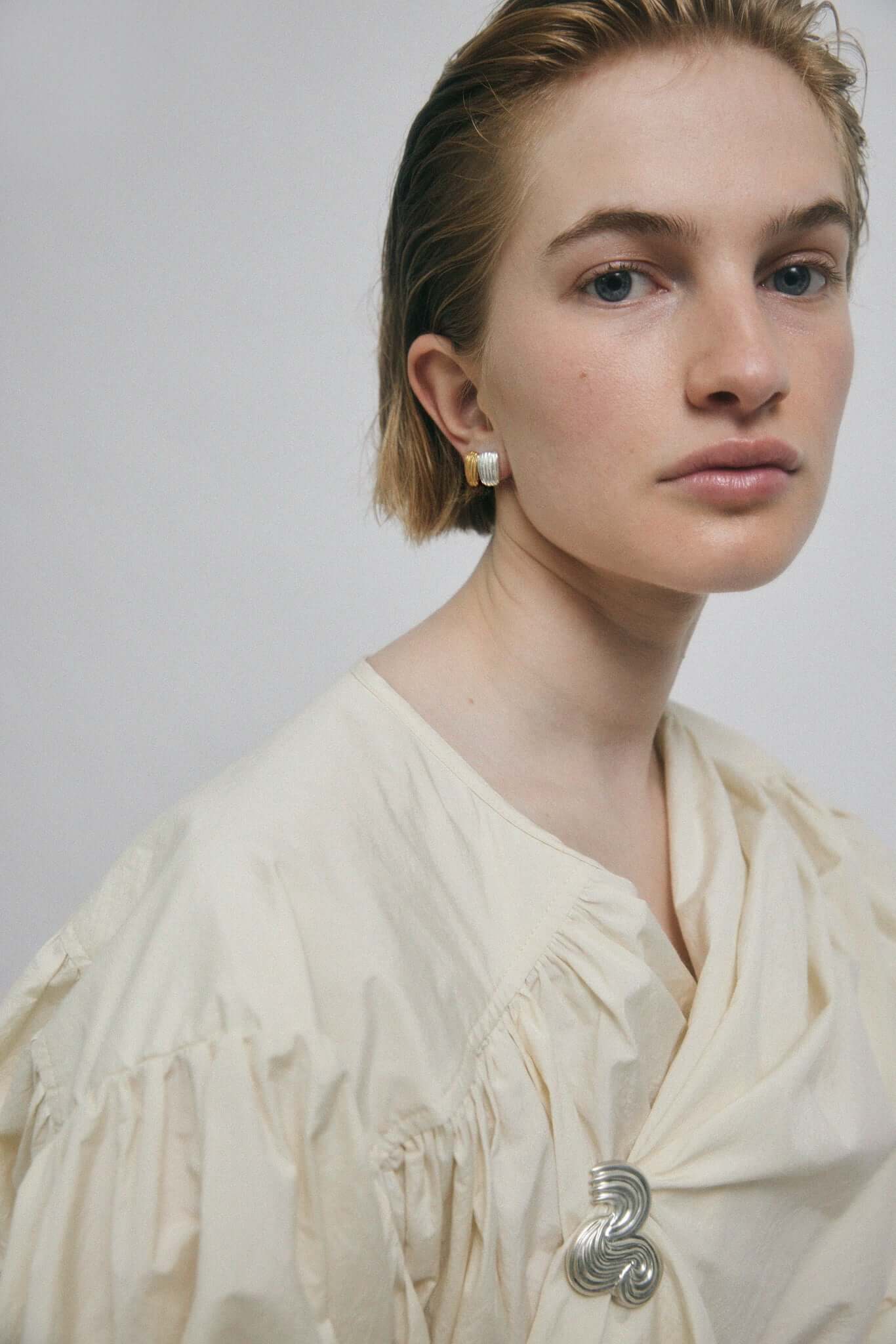 Woman wearing a silver brooche