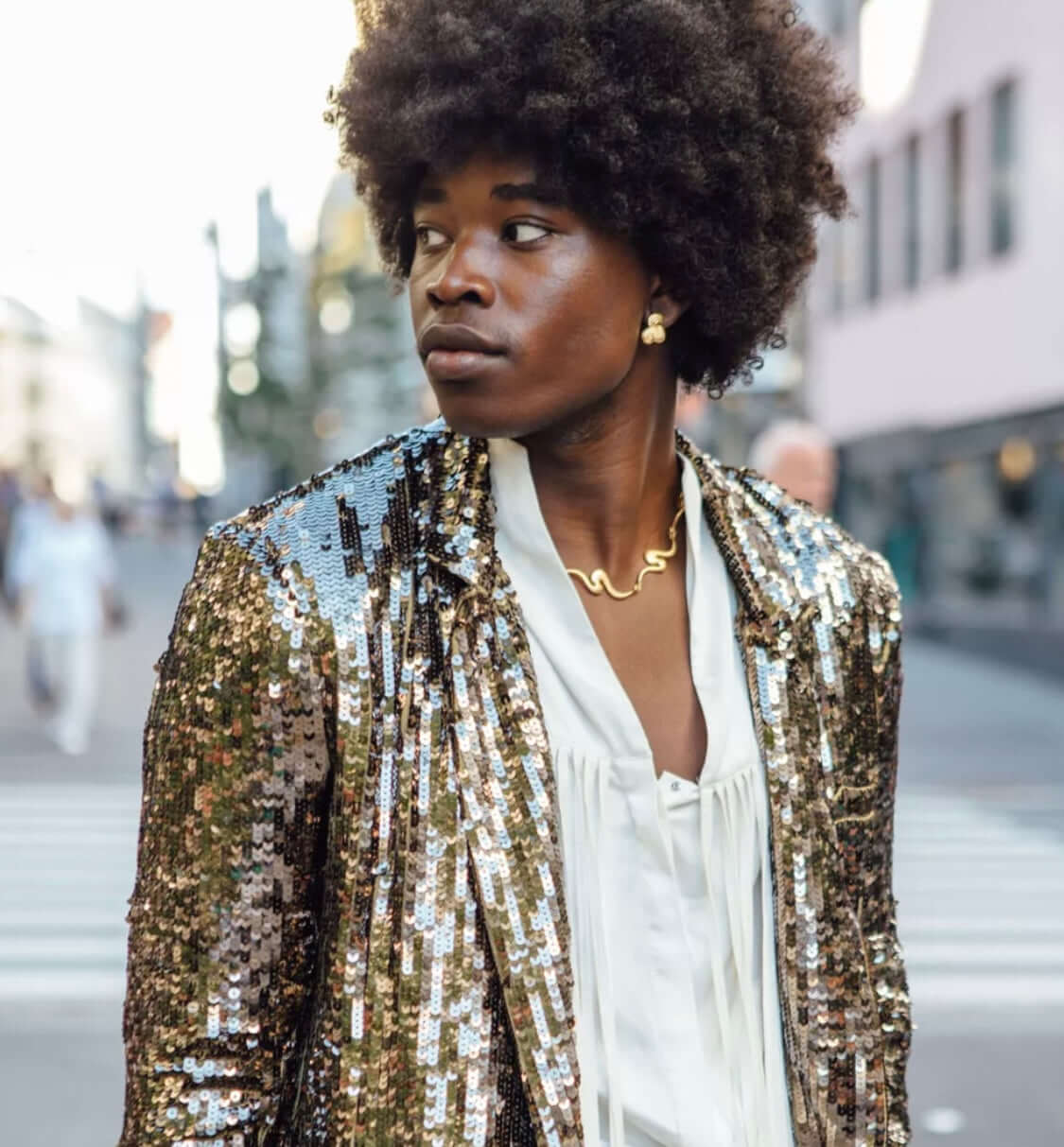 Man with afro, wearing gold jewelry